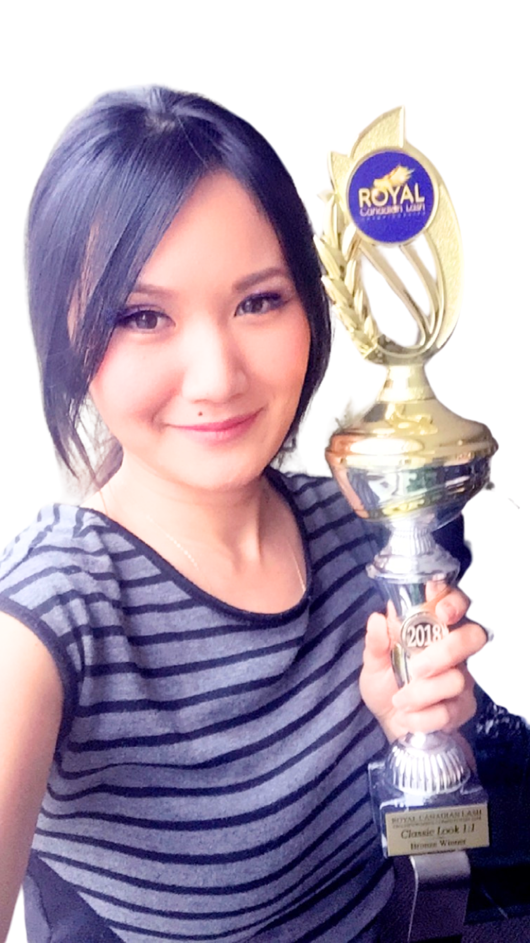 award winning lash artist, Rach Kado, holding a lash trophy from royal lash competition in 2018.